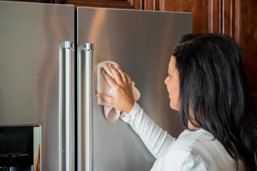 woman-cleaning-refrigerator-exterior